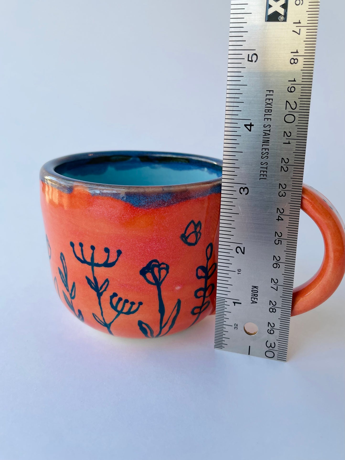 Coral Mug with Blue Flowers